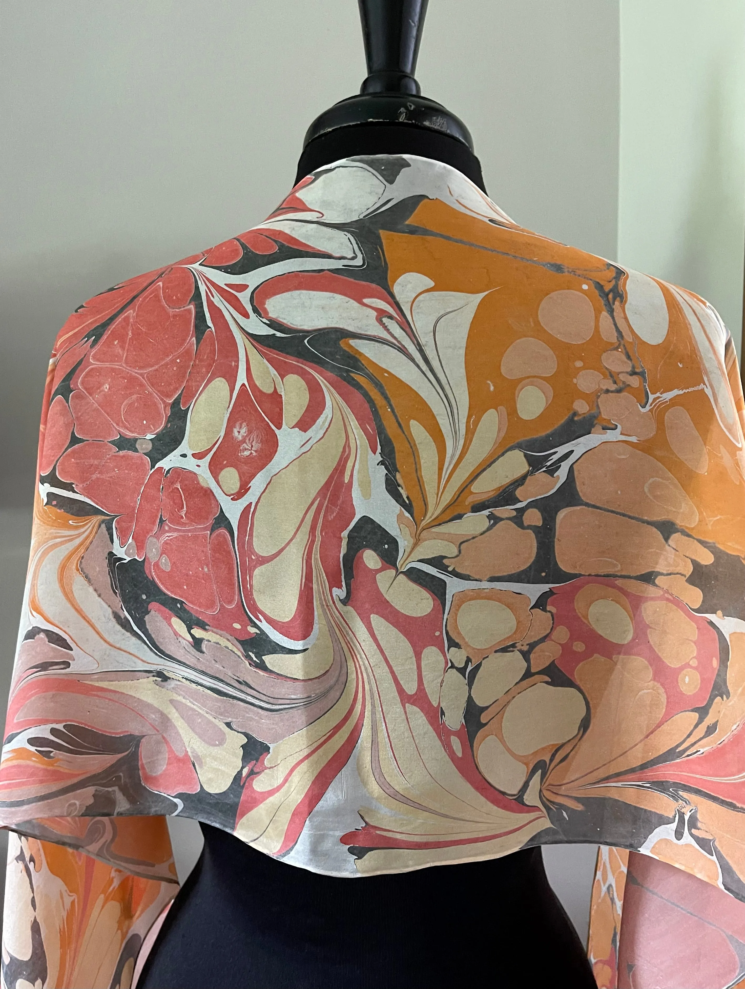 Orange very random water marbled 8mm Habotai silk.  Hang on the wall, use as a table runner or wear this unique piece