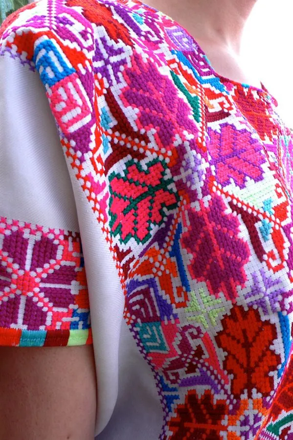 Pink red and white cross-stitched blouses Mexico